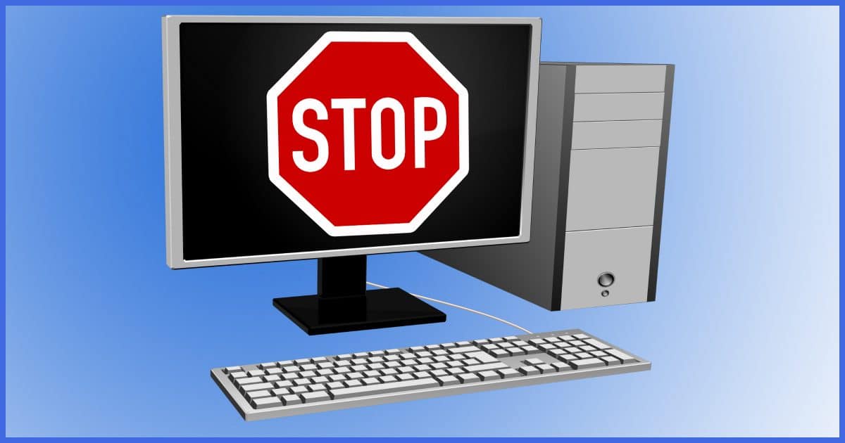 Desktop computer with a Stop sign on the screen.