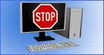 Desktop computer with a Stop sign on the screen.