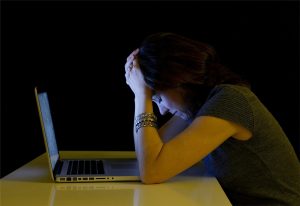 Head in Hands over a Laptop