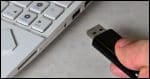 Someone inserting or removing a USB thumbdrive.