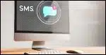 A modern desktop computer screen displaying an incoming text message icon, symbolizing SMS functionality without a phone.